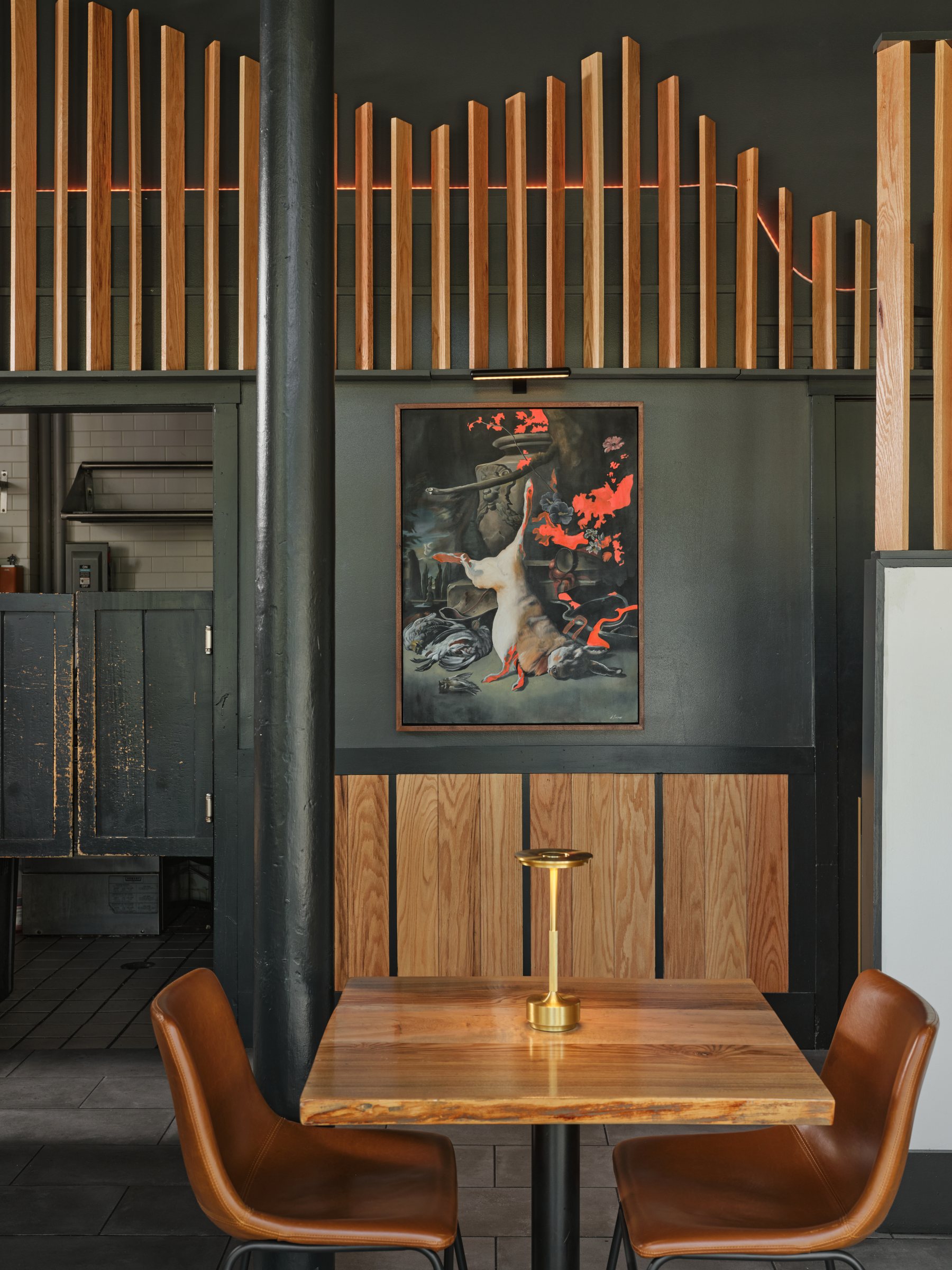 A table beneath the painting at Hunt & Alpine